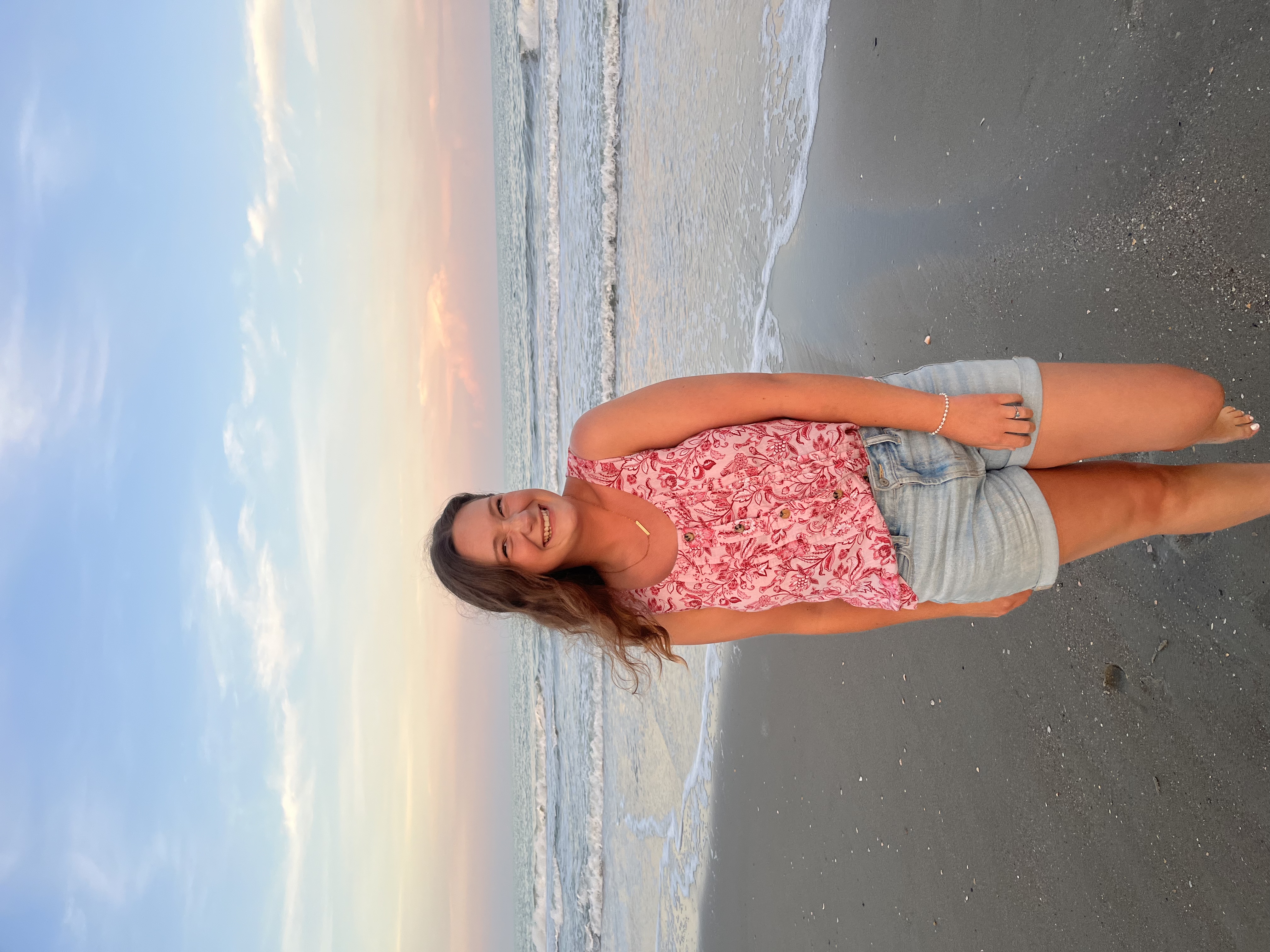 A picture of me on the beach at sunset